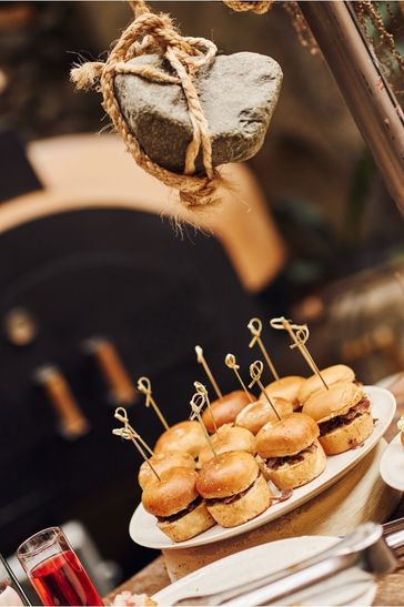 A spread of sandwiches and assorted dishes arranged on a table, inviting for a meal or social event