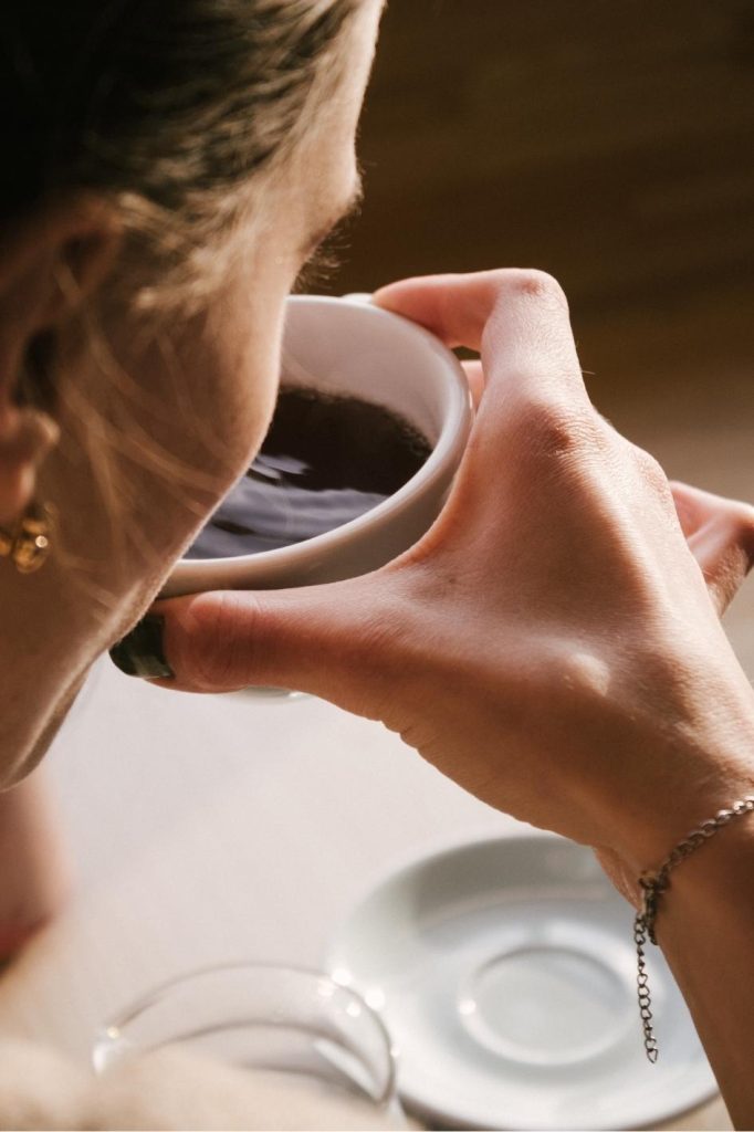 Woman enjoying a cup of coffee in a cozy atmosphere