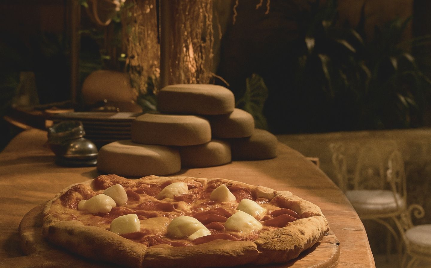 A delicious pizza topped with cheese and pepperoni sits on a rustic wooden table