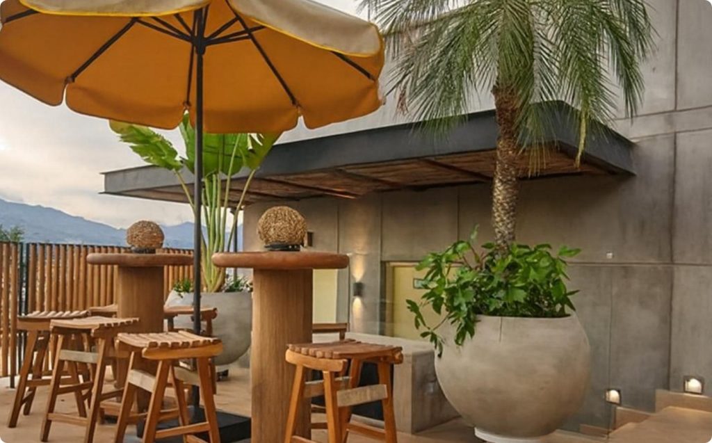Cozy patio with table and chairs under an umbrella, ideal for local cooking classes in Medellín.